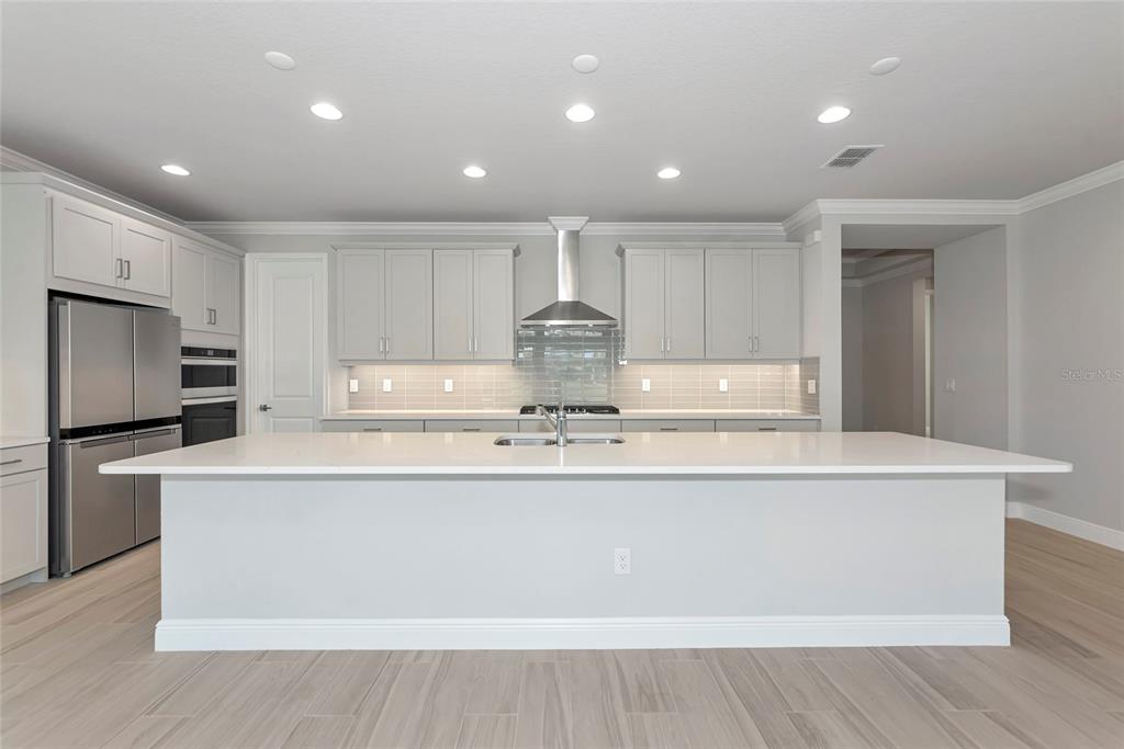 5798 Long Shore Loop Sarasota, FL 34238 - Photo 6 of 40 a view of kitchen with stainless steel appliances granite countertop cabinets and wooden floor