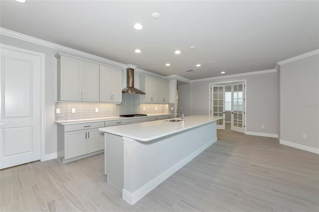 5798 Long Shore Loop Sarasota, FL 34238 - Photo 10 of 40 a large kitchen with kitchen island a sink stainless steel appliances and cabinets