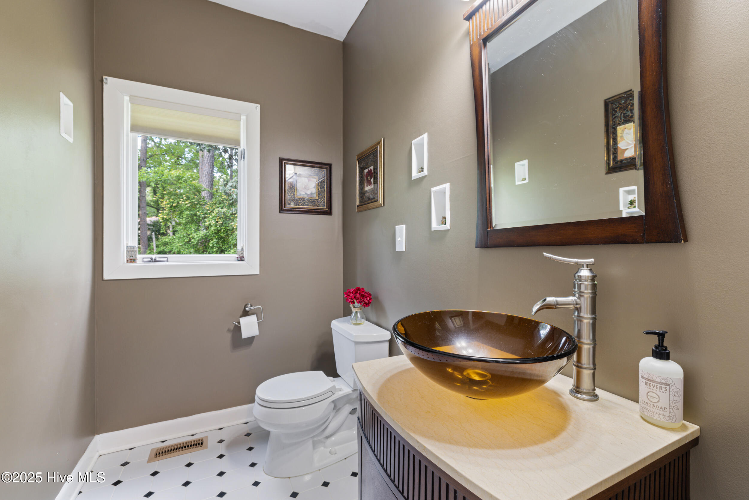 145 Meadowlark Road Goldsboro, NC 27534 - Photo 31 of 74 1/2 Bath with beautiful tile floor and sink that is a literal piece of furniture