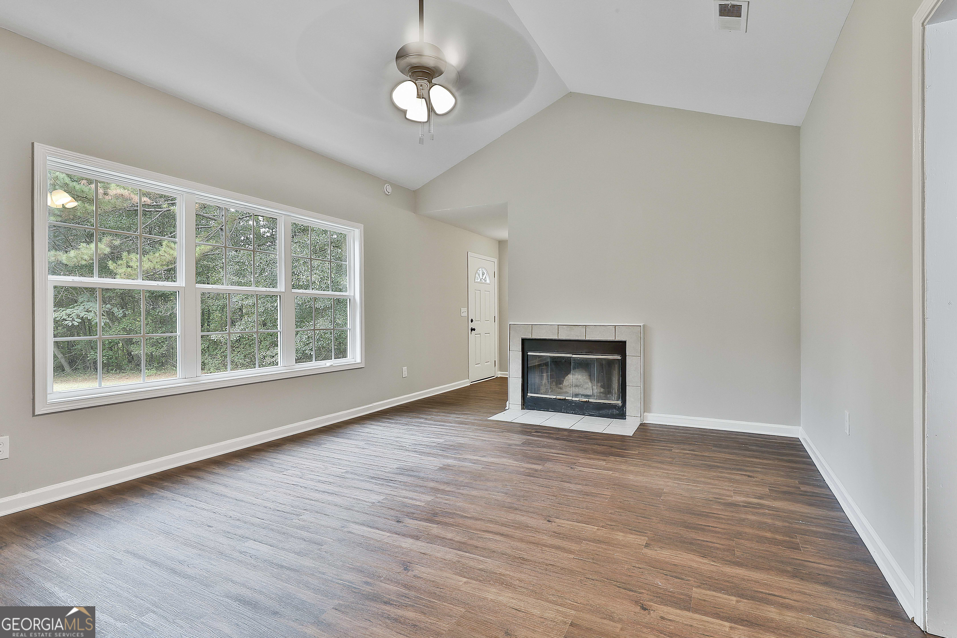 1606 Mcwilliams Barber Road Luthersville, GA 30251 - Photo 14 of 38 wooden floor fireplace and windows in an empty room