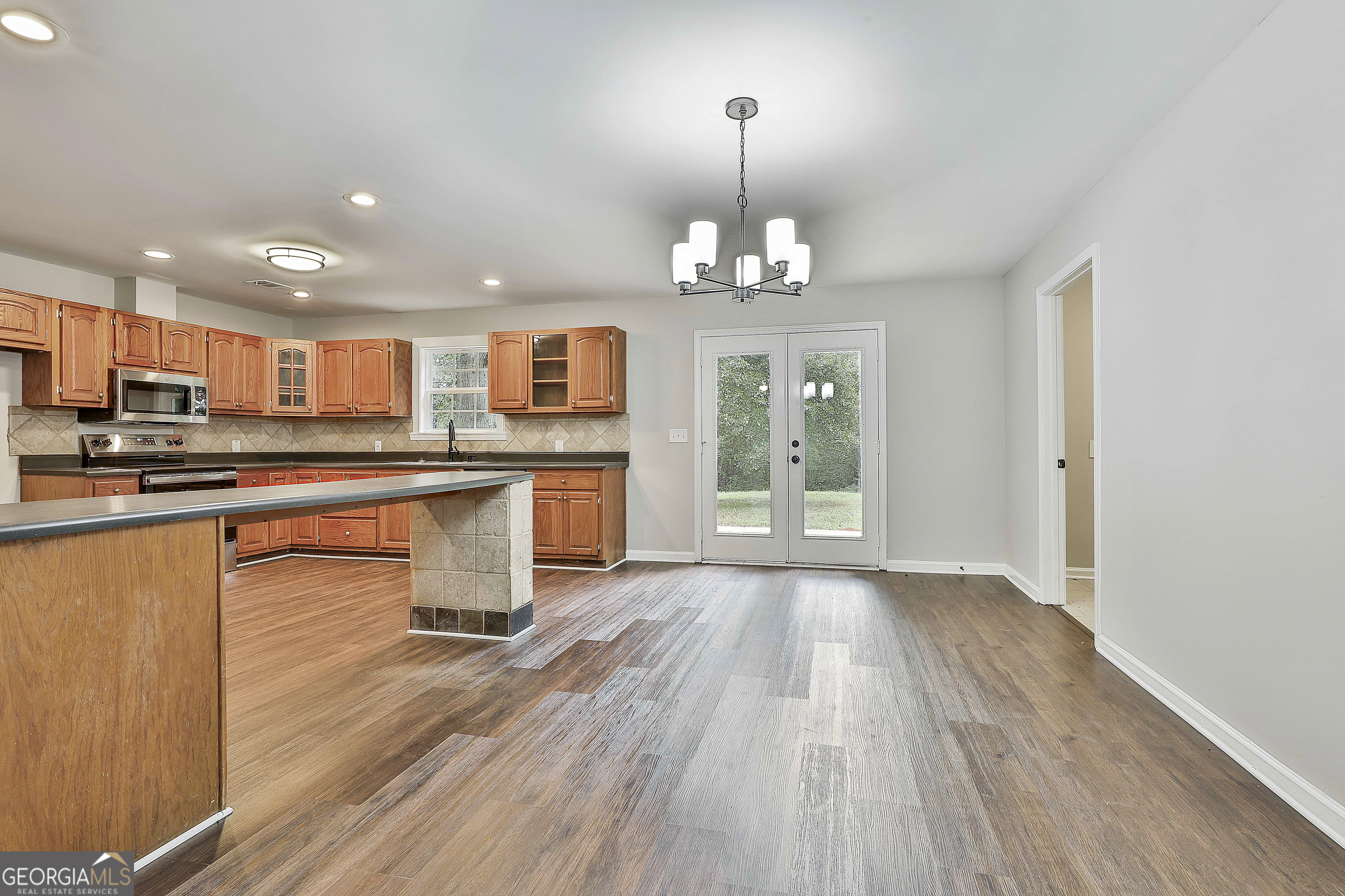 1606 Mcwilliams Barber Road Luthersville, GA 30251 - Photo 16 of 38 an open kitchen with kitchen island and stainless steel appliances