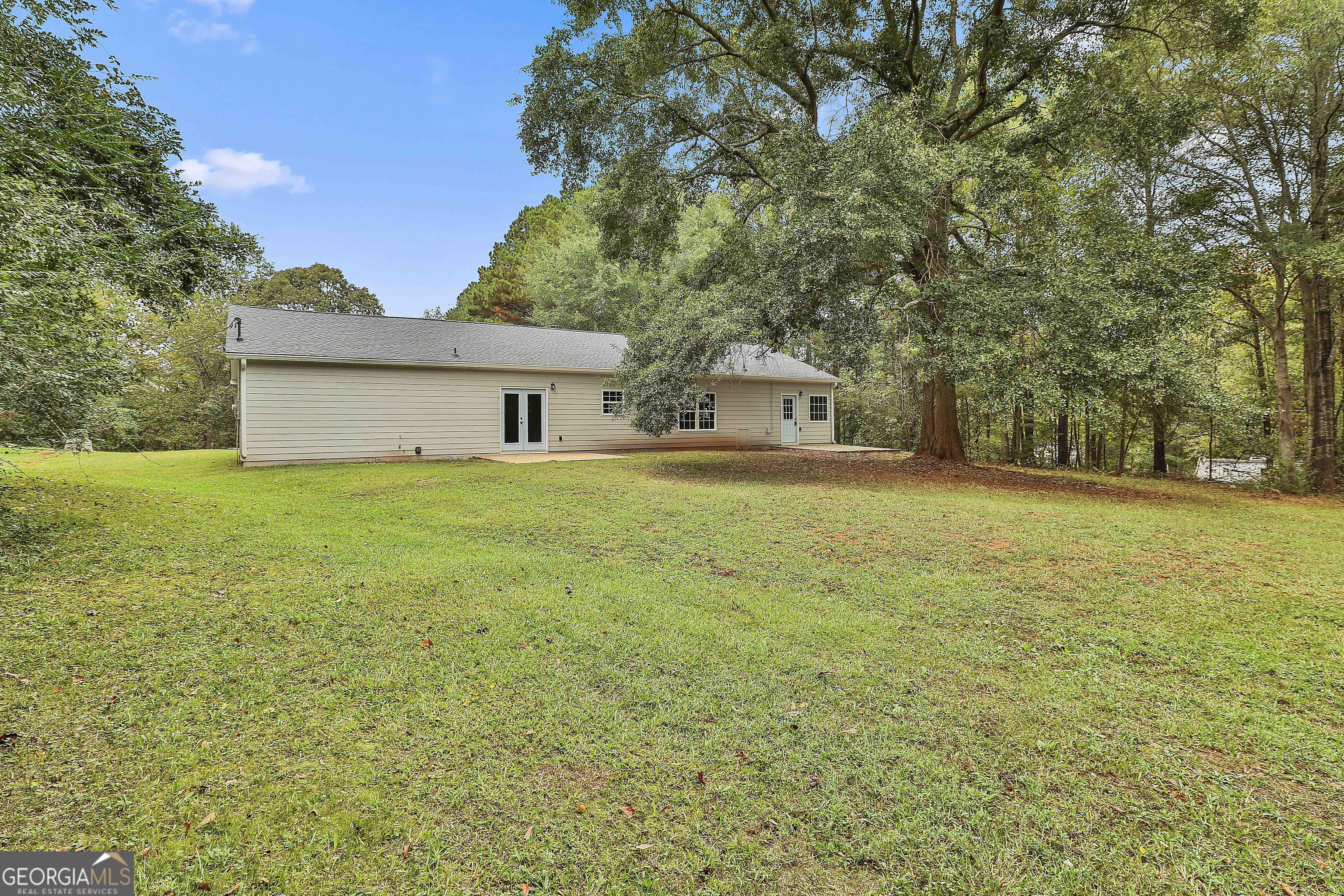 1606 Mcwilliams Barber Road Luthersville, GA 30251 - Photo 35 of 38 a view of a house with a big yard and palm trees