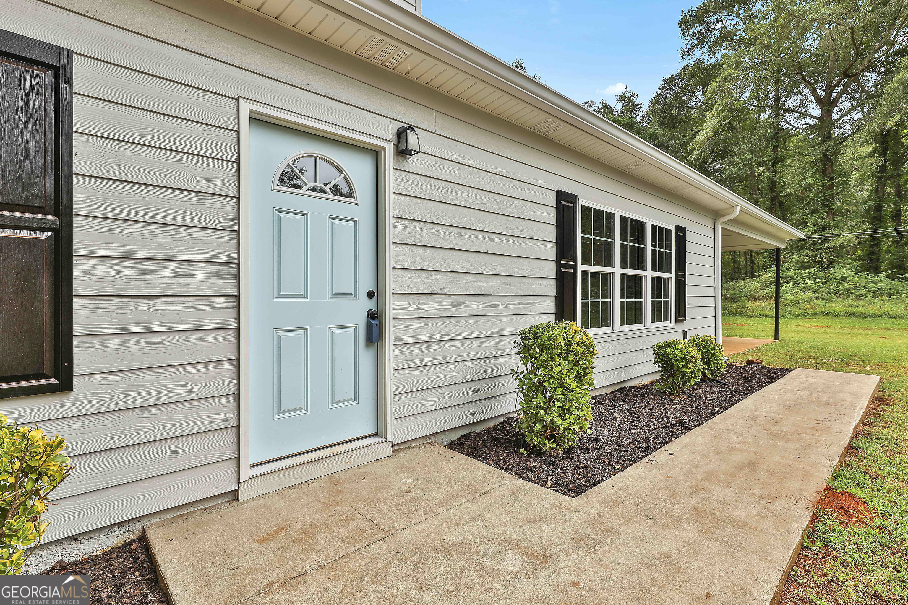 1606 Mcwilliams Barber Road Luthersville, GA 30251 - Photo 9 of 38 a front view of a house with garden