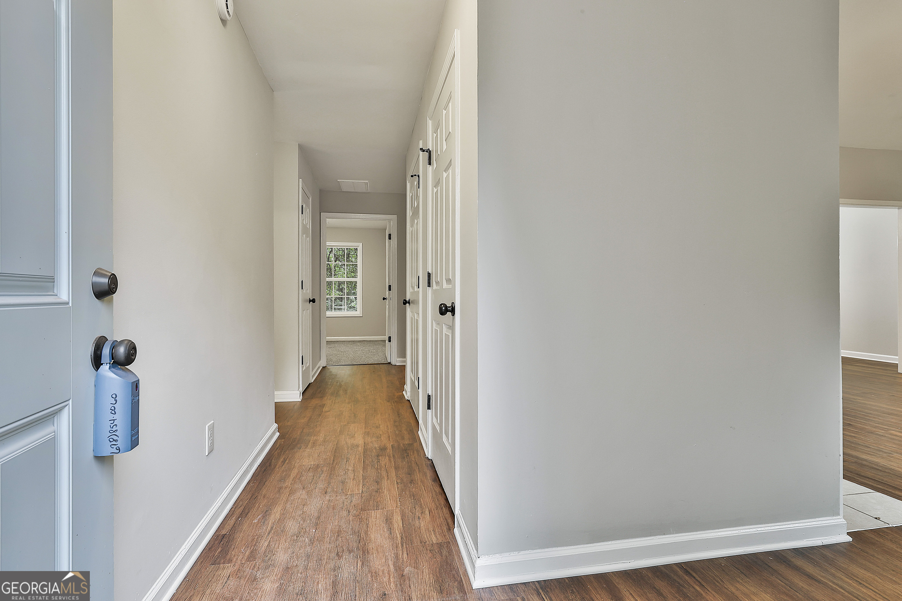 1606 Mcwilliams Barber Road Luthersville, GA 30251 - Photo 10 of 38 a view of a hallway with wooden floor and staircase
