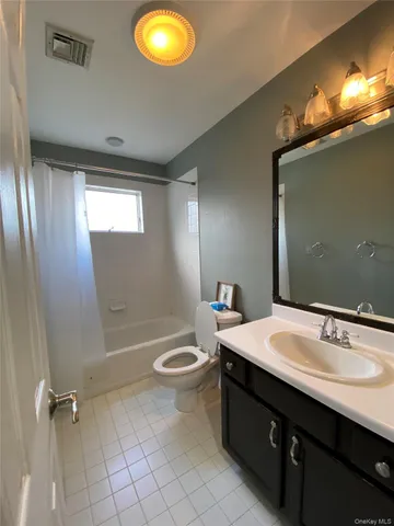 a bathroom with a sink double vanity and a mirror
