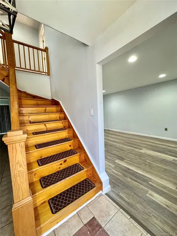 a view of a deck with chairs and wooden fence