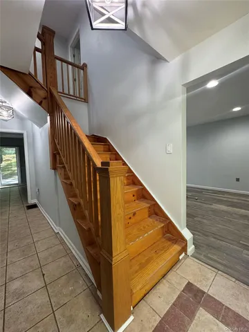a view of staircase with white walls and stairs