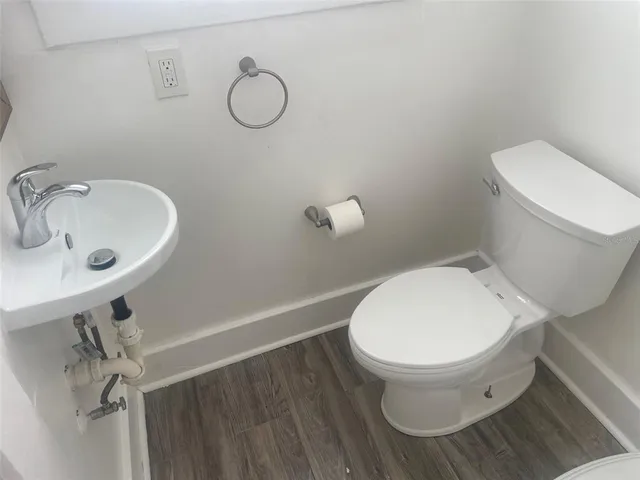 a white toilet sitting next to a bathroom sink