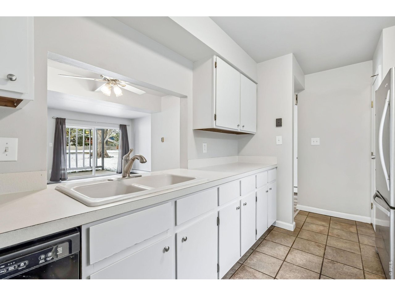 809 East Drake Road, Unit C107 Fort Collins, CO 80525 - Photo 5 of 24 a kitchen with a sink cabinets and window