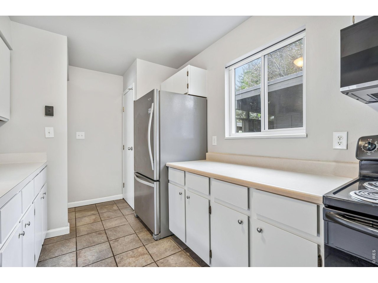 809 East Drake Road, Unit C107 Fort Collins, CO 80525 - Photo 6 of 24 a kitchen with a refrigerator and a sink