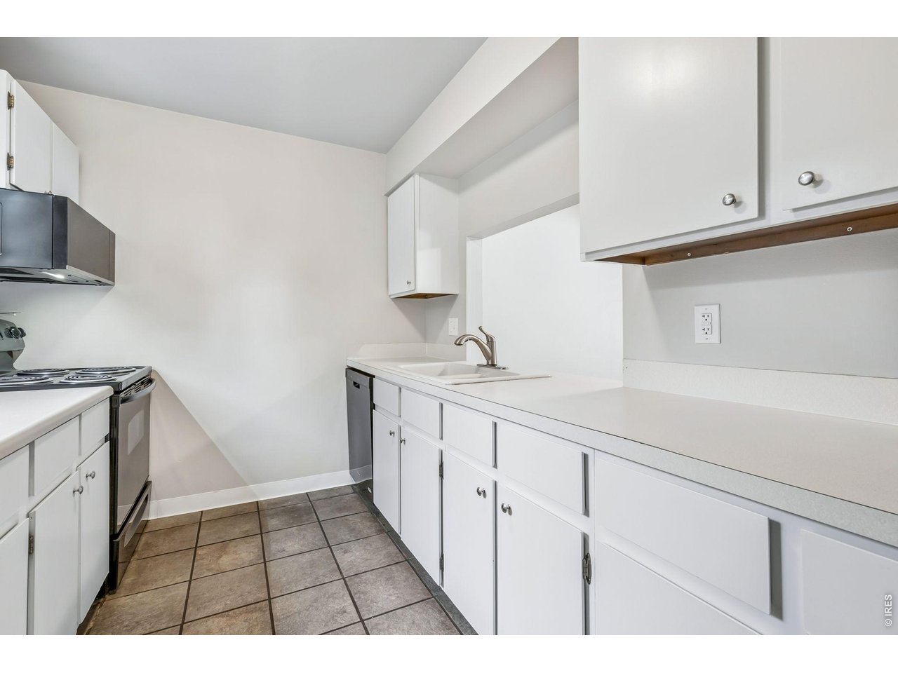 809 East Drake Road, Unit C107 Fort Collins, CO 80525 - Photo 7 of 24 a kitchen with a sink and cabinets