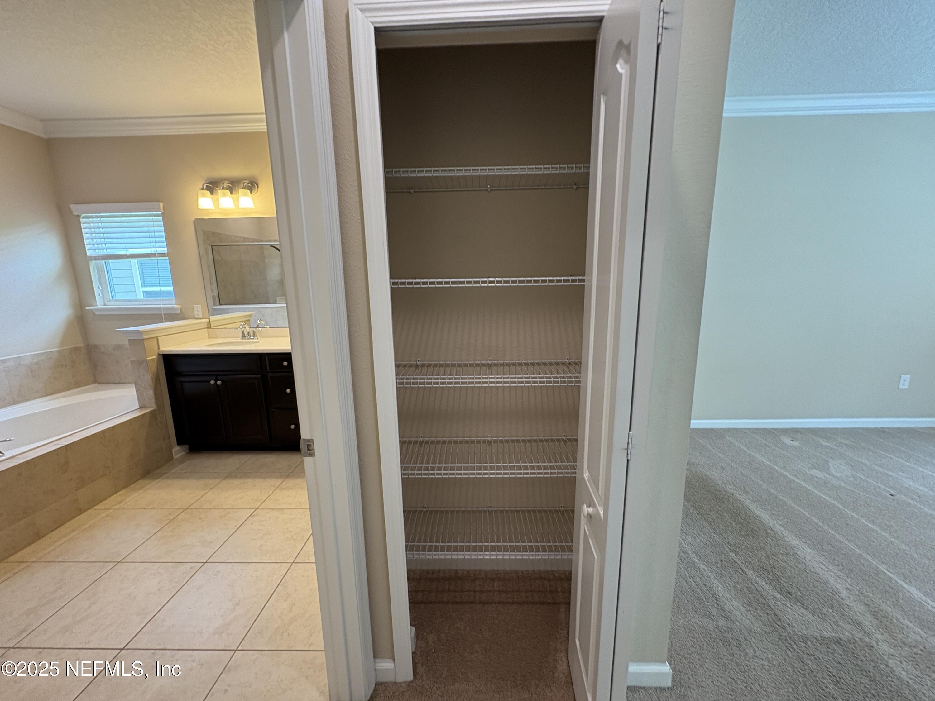 173 Athens Drive St. Augustine, FL 32092 - Photo 11 of 25 a bathroom with a sink and mirror