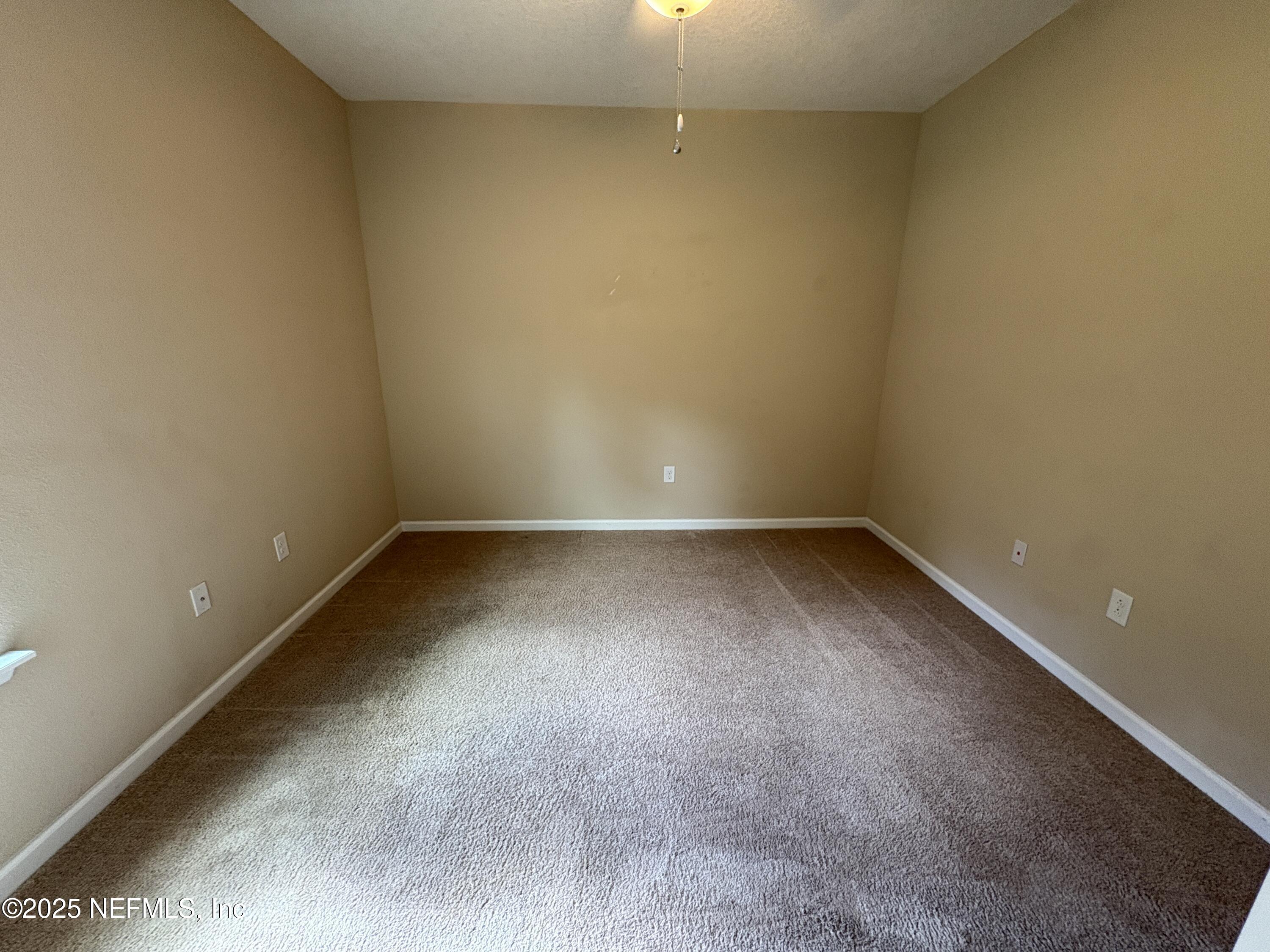 173 Athens Drive St. Augustine, FL 32092 - Photo 13 of 25 a view of a room with wooden floor and a window