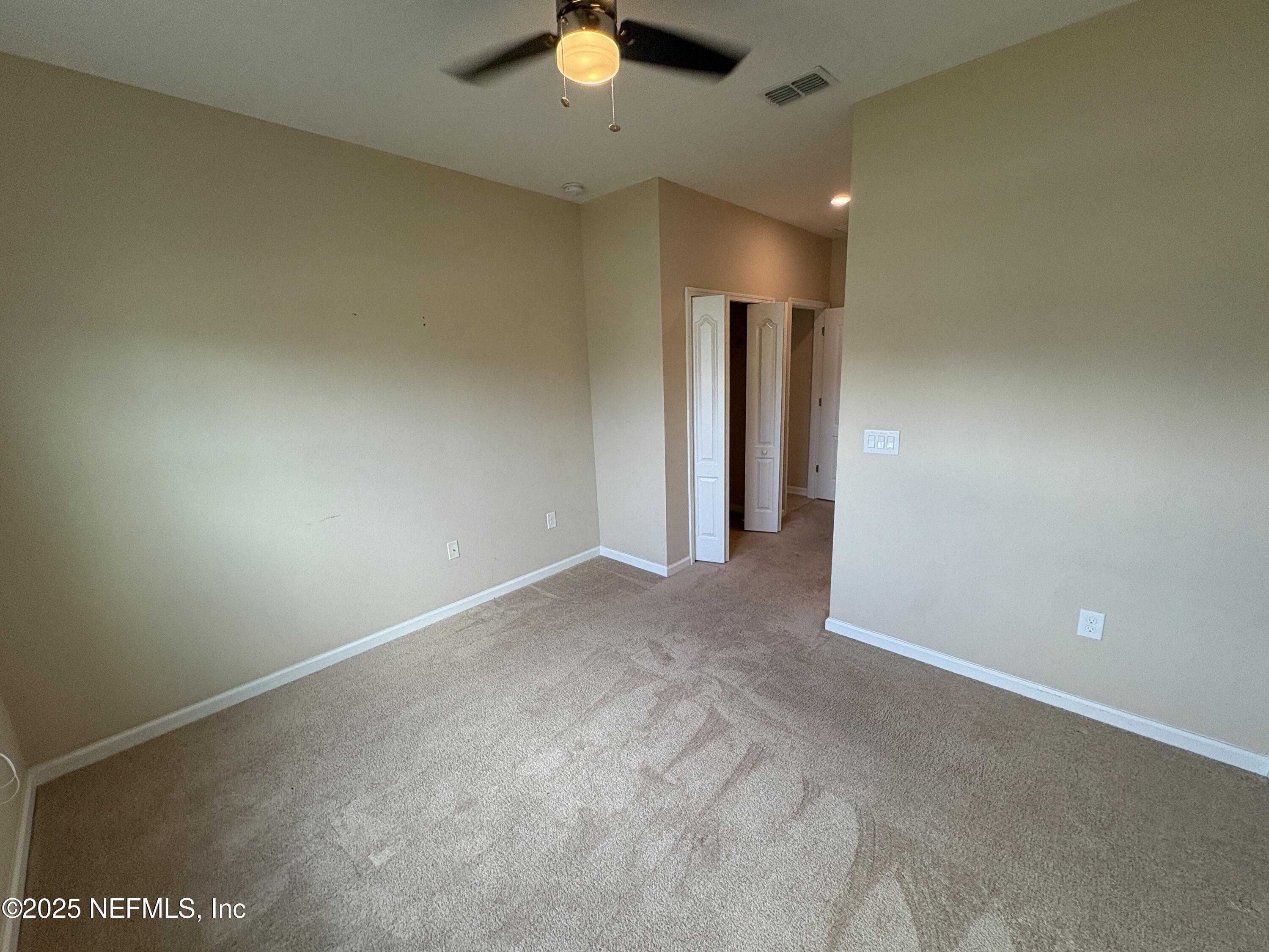 173 Athens Drive St. Augustine, FL 32092 - Photo 19 of 25 an empty room with a empty space and a ceiling fan