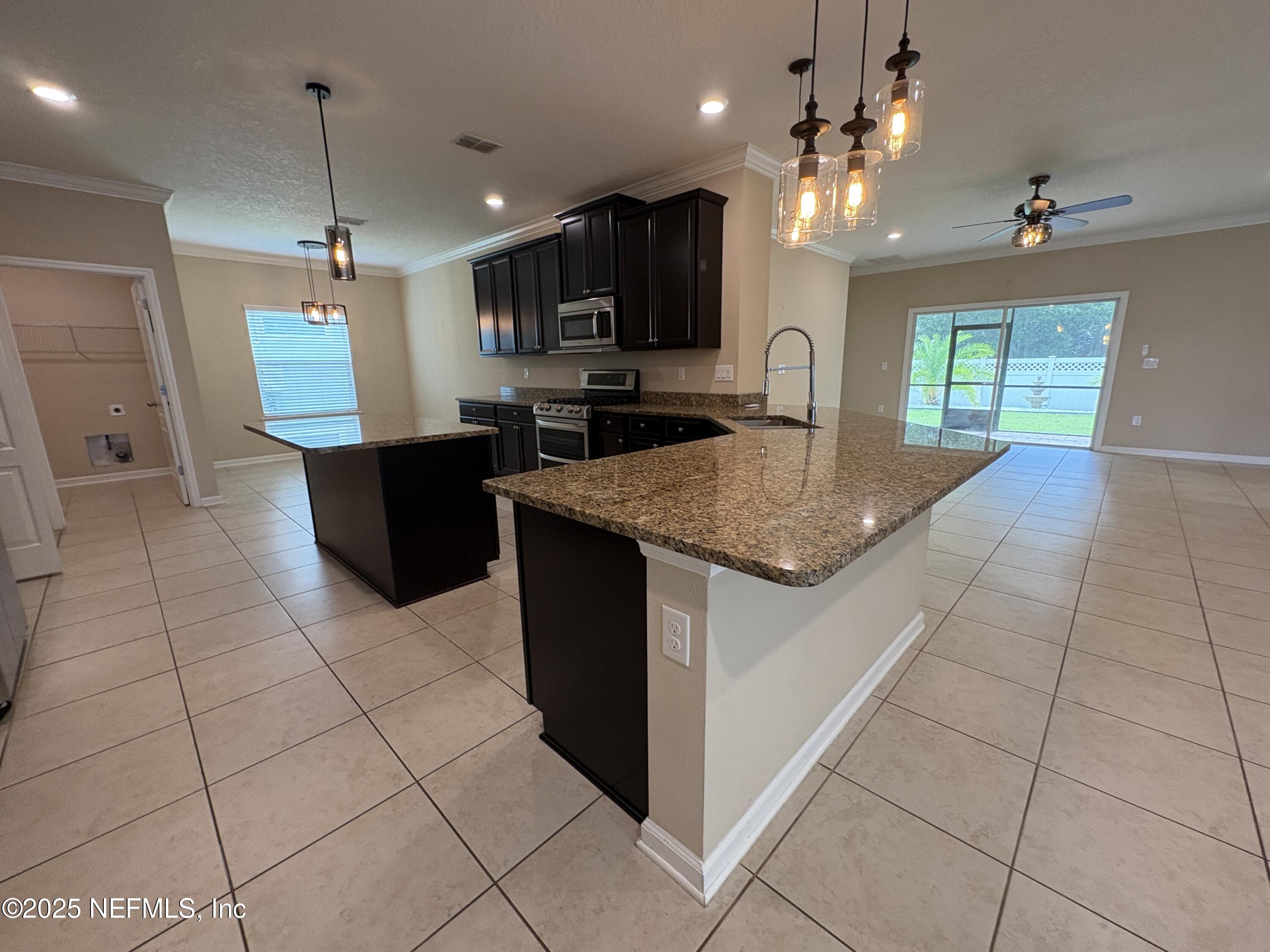 173 Athens Drive St. Augustine, FL 32092 - Photo 2 of 25 a kitchen with a sink a counter top space cabinets and appliances