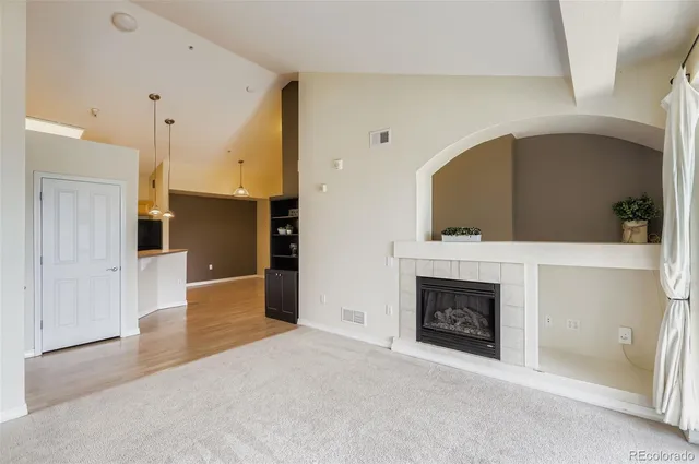a view of an empty room with a fireplace