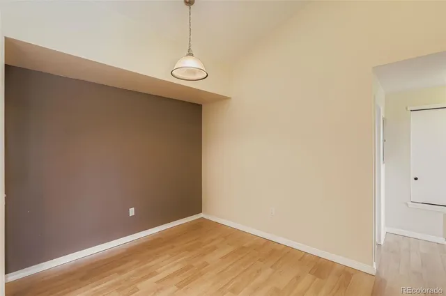 a view of a room with a hallway and a chandelier