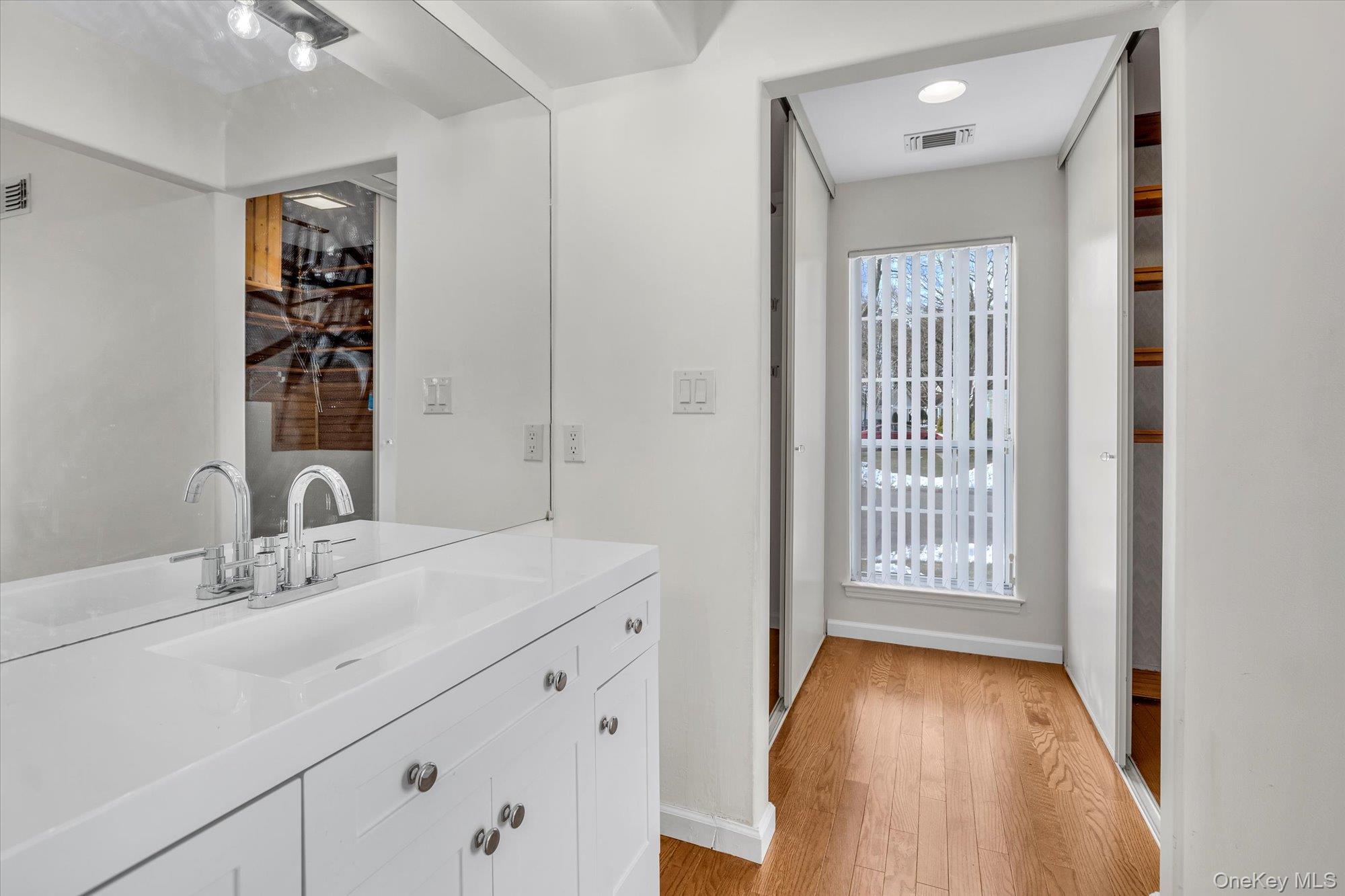 289 Glen Drive Ridge, NY 11961 - Photo 13 of 19 a bathroom with a sink and a mirror