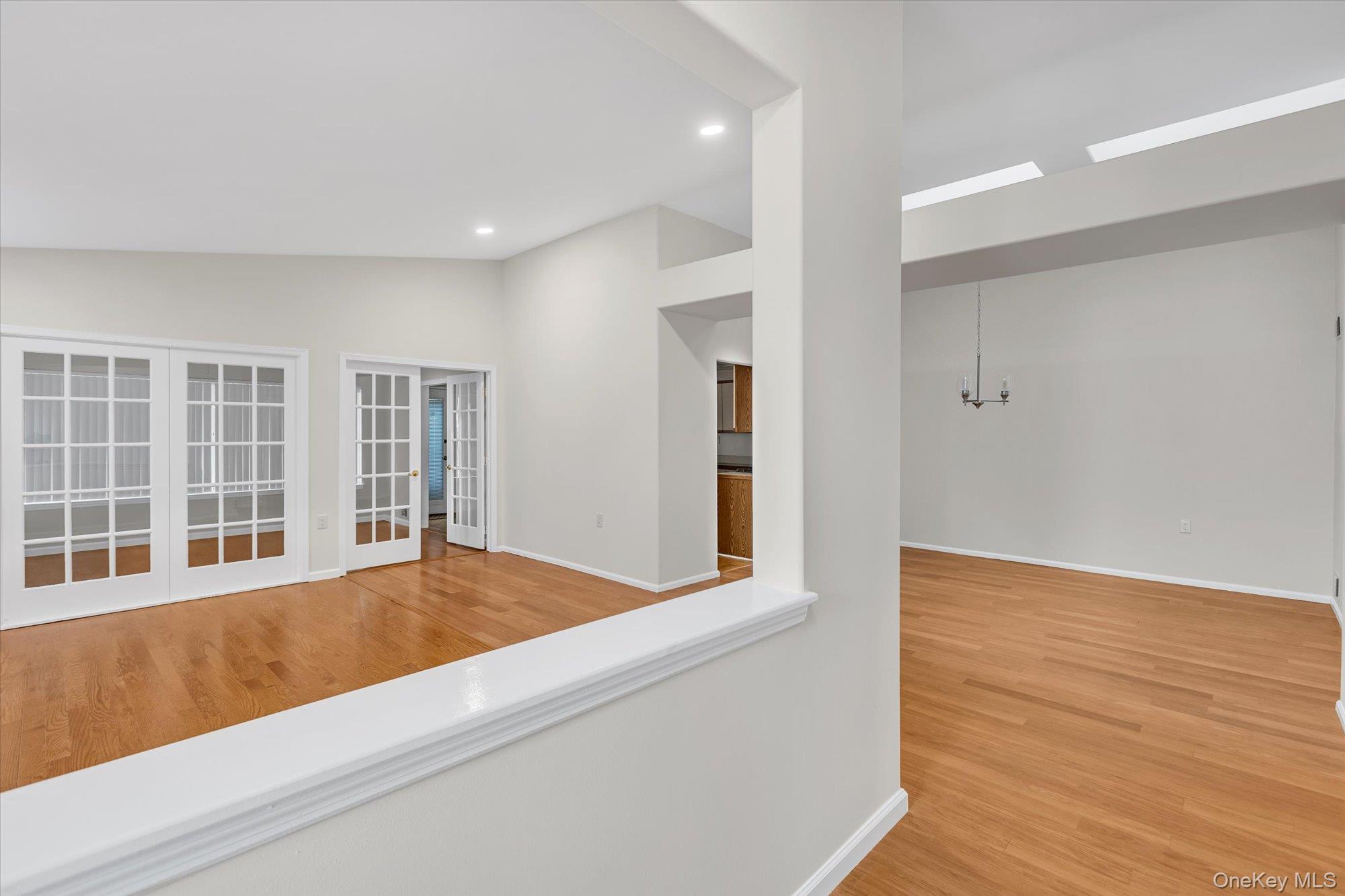 289 Glen Drive Ridge, NY 11961 - Photo 16 of 19 a view of an empty room with wooden floor and a window