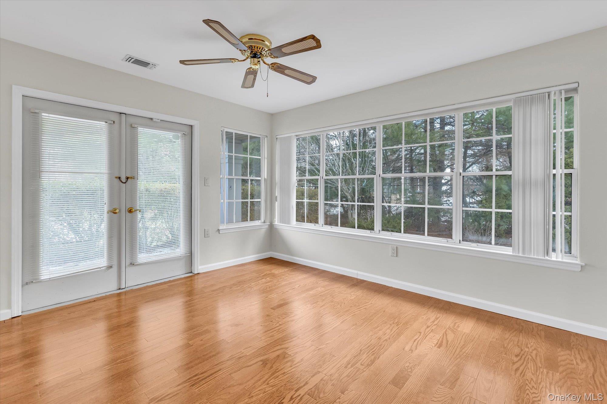 289 Glen Drive Ridge, NY 11961 - Photo 4 of 19 a view of an empty room with a window and wooden floor