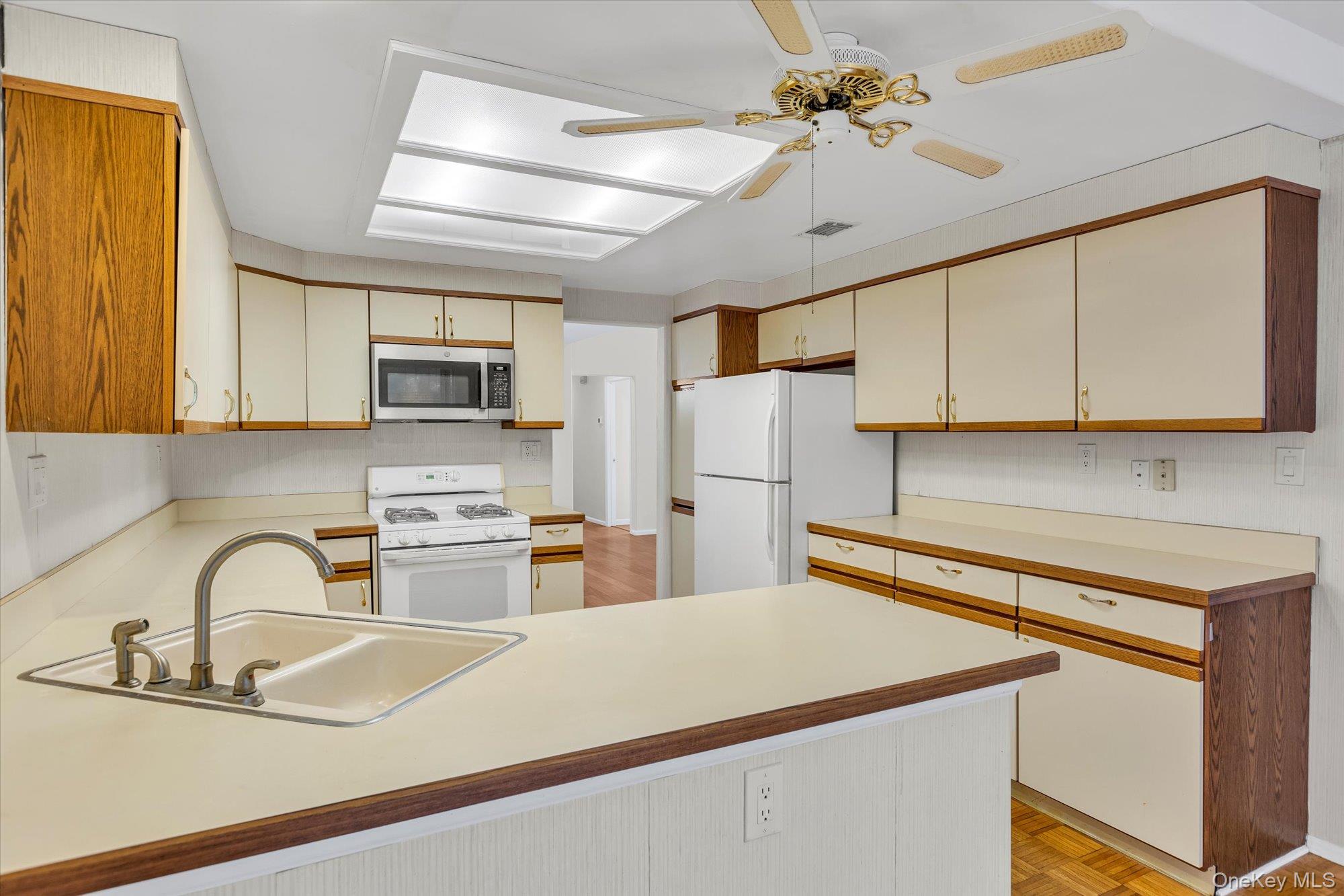 289 Glen Drive Ridge, NY 11961 - Photo 6 of 19 a kitchen with kitchen island a sink appliances and cabinets