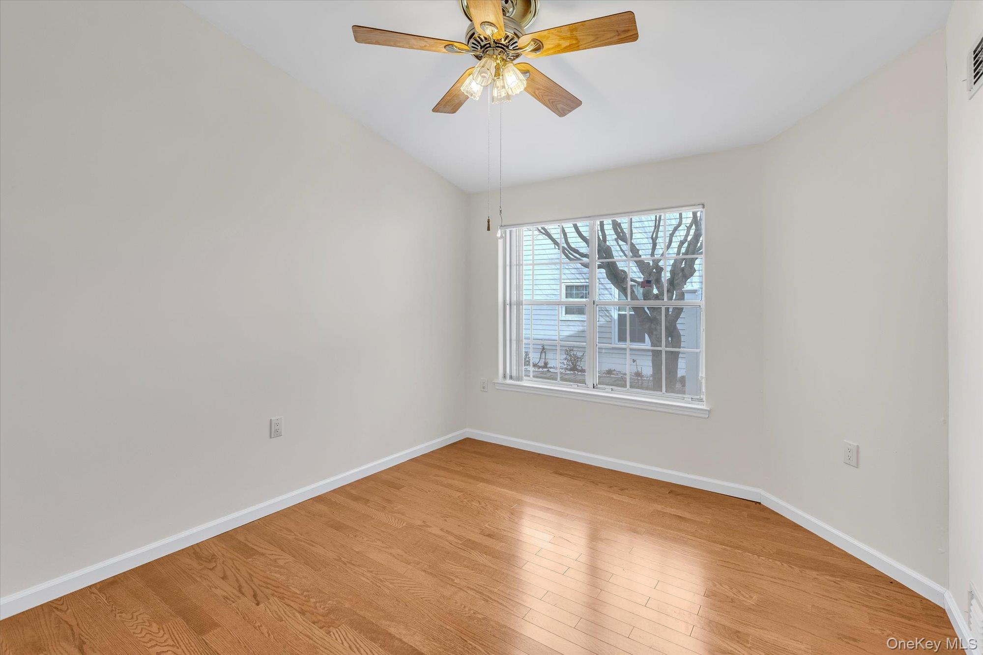 289 Glen Drive Ridge, NY 11961 - Photo 10 of 19 an empty room with a window and a fan