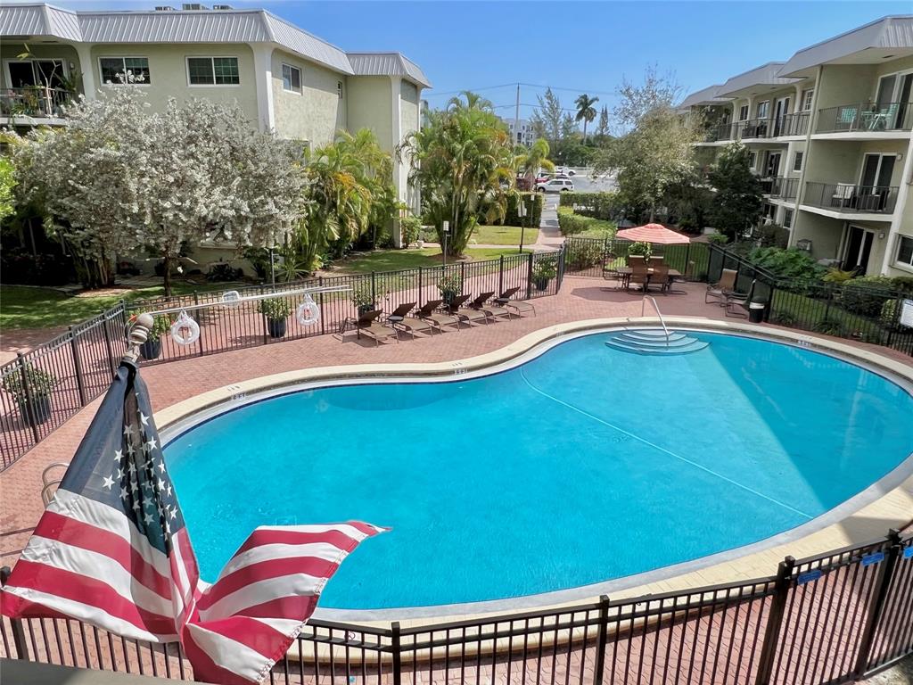 3002 Northeast 5th Terrace, Unit 209B Wilton Manors, FL 33334 - Photo 1 of 25 a view of a swimming pool with a patio