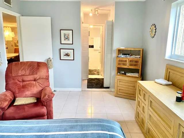 a white toilet sitting next to a bath tub and a shower