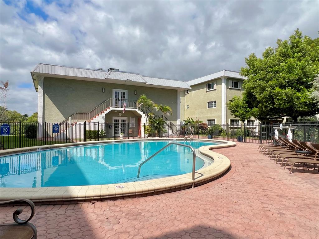 3002 Northeast 5th Terrace, Unit 209B Wilton Manors, FL 33334 - Photo 18 of 25 a view of a swimming pool with a patio
