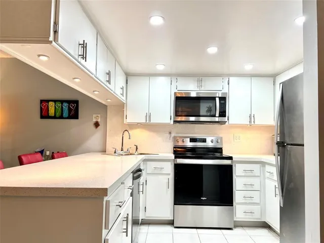 a kitchen that has a sink and a stove in it