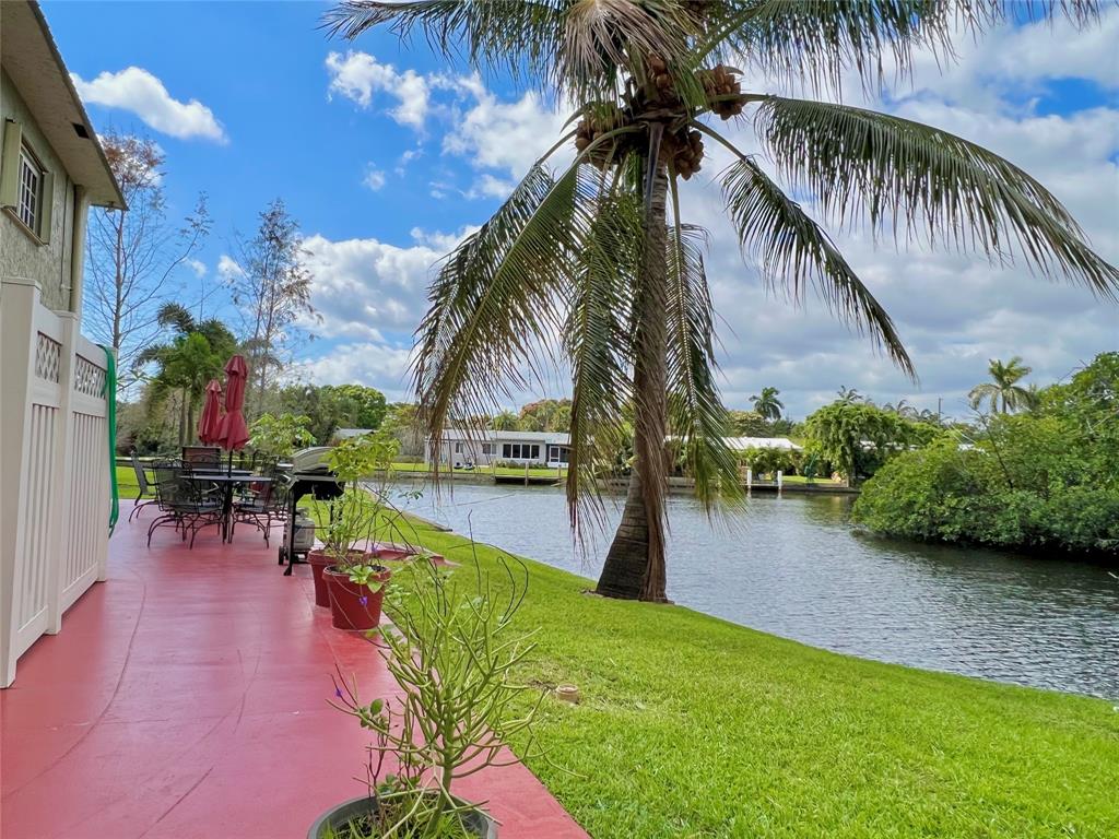 3002 Northeast 5th Terrace, Unit 209B Wilton Manors, FL 33334 - Photo 22 of 25 a swimming pool with outdoor seating
