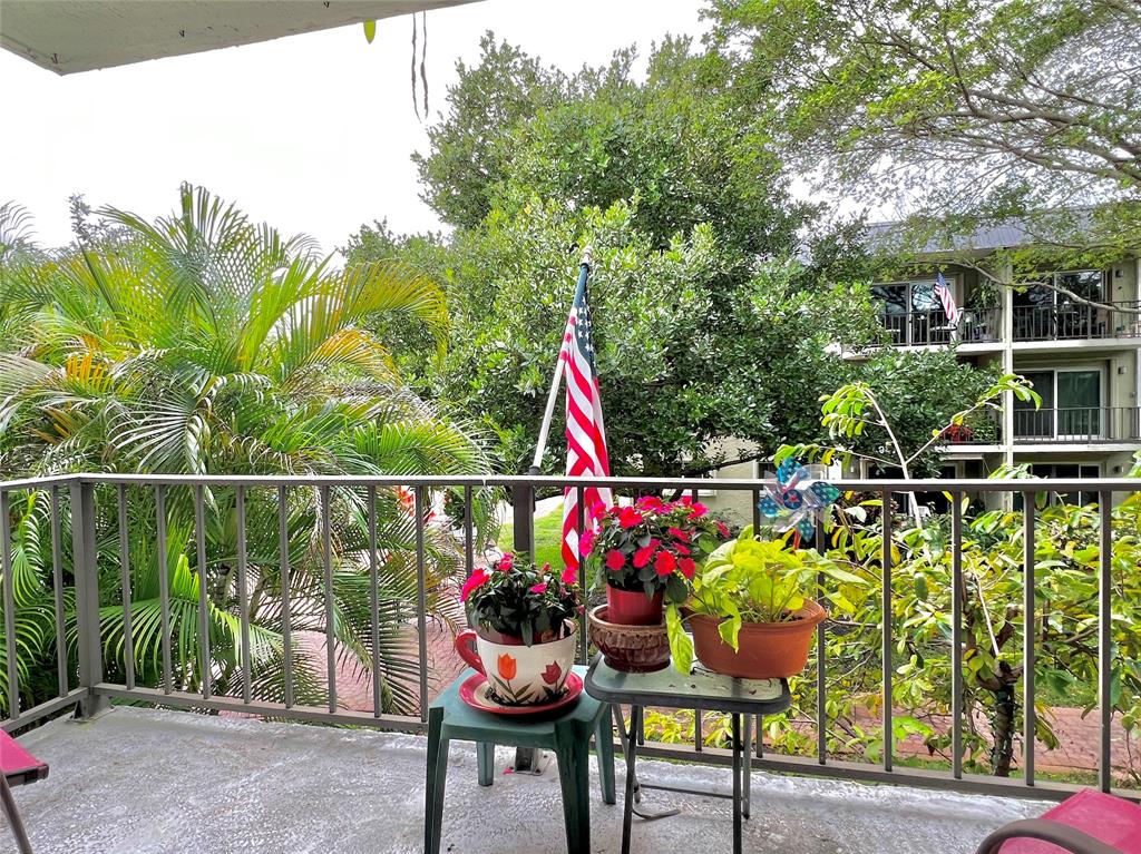 3002 Northeast 5th Terrace, Unit 209B Wilton Manors, FL 33334 - Photo 25 of 25 a view of a chairs and table in the patio