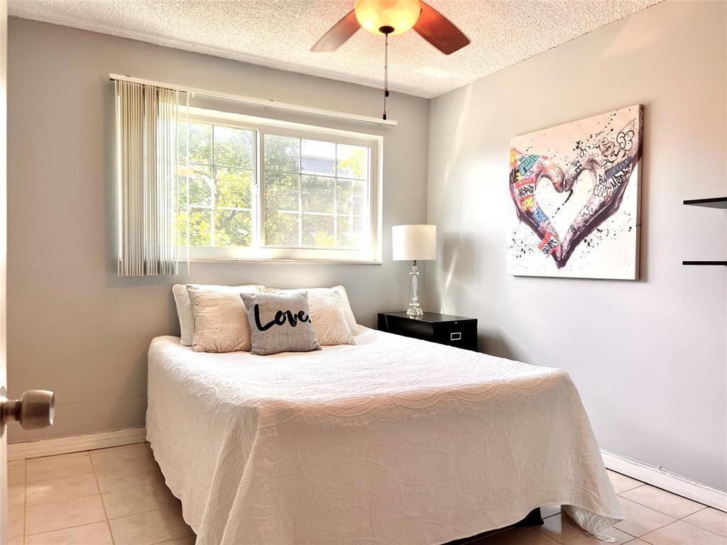 3002 Northeast 5th Terrace, Unit 209B Wilton Manors, FL 33334 - Photo 7 of 25 a bedroom with a bed and a window