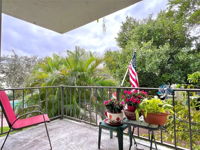 a view of a house with a backyard and sitting area