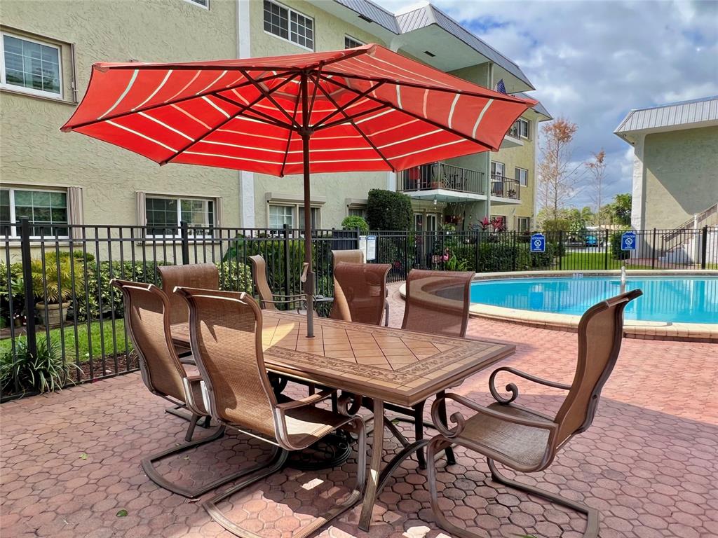 3002 Northeast 5th Terrace, Unit 209B Wilton Manors, FL 33334 - Photo 10 of 25 a view of a house with a backyard and sitting area