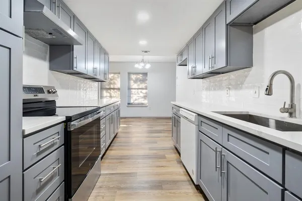 a kitchen with stainless steel appliances granite countertop a sink and cabinets