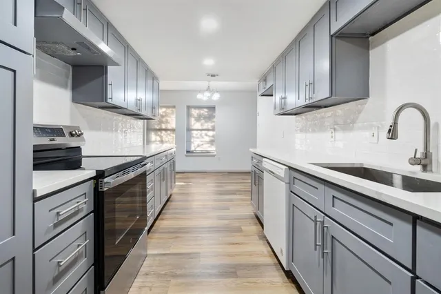 a kitchen with stainless steel appliances granite countertop a sink and cabinets