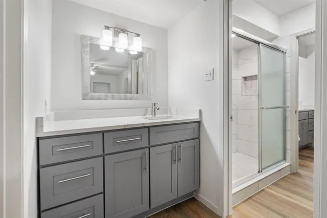 a bathroom with a shower sink and mirror