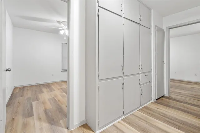 a view of a room with wooden floor