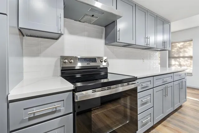 a kitchen with appliances cabinets and a window