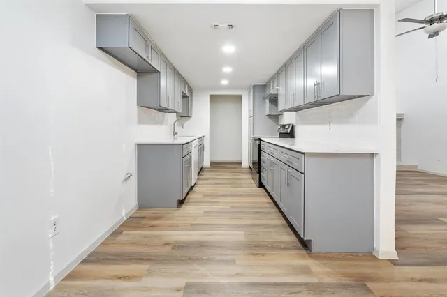 a kitchen with stainless steel appliances granite countertop a sink and cabinets