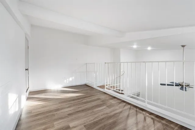 a view of a room with wooden floor