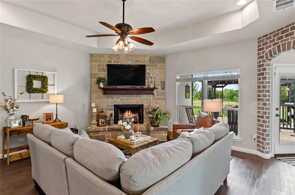 6093 Farm To Market Road 730 North Decatur, TX 76234 - Photo 5 of 28 a living room with furniture a fireplace and a flat screen tv