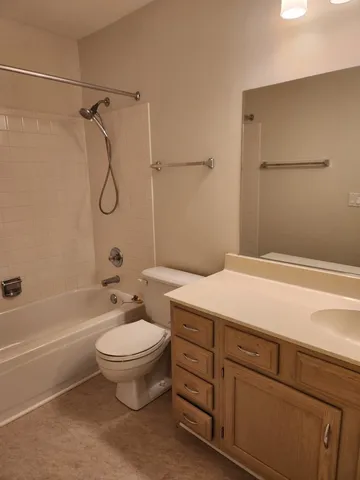 a bathroom with a toilet sink and shower