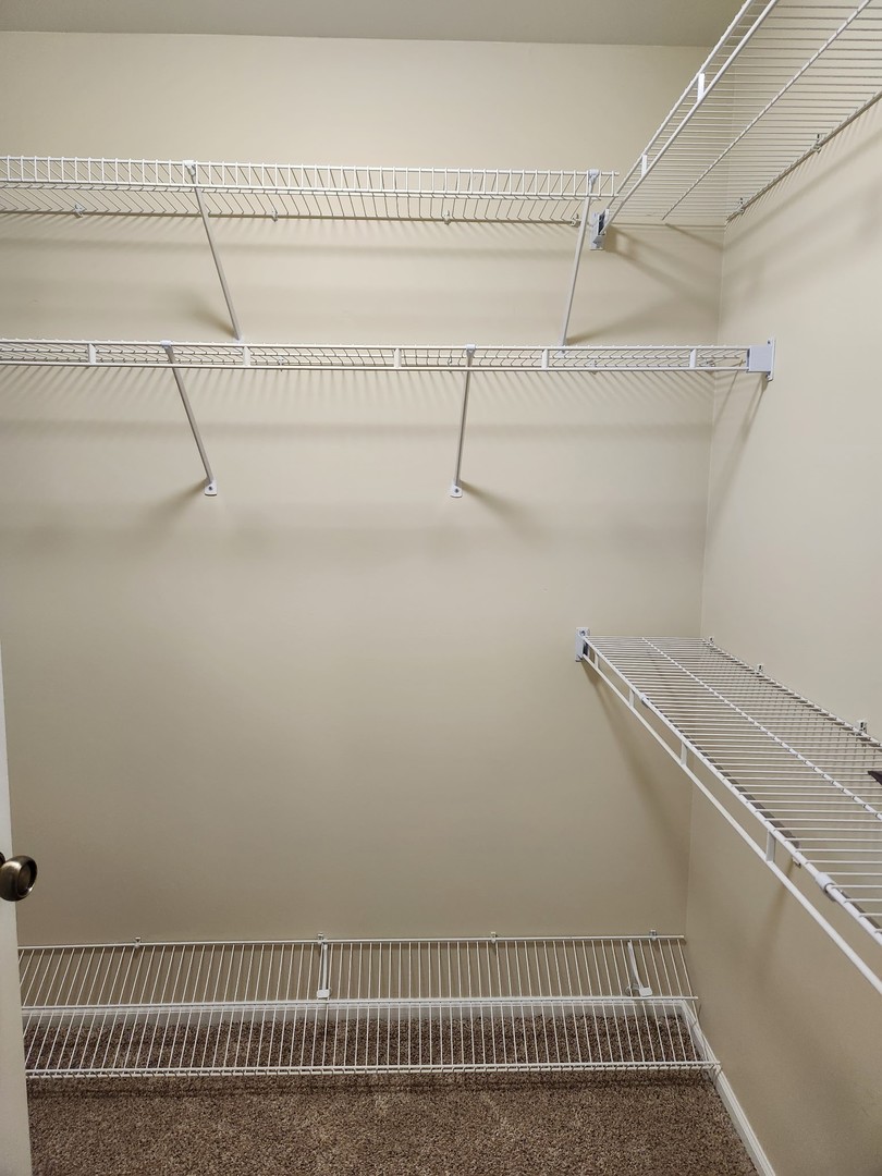 1403 Plum Court, Unit B Mount Prospect, IL 60056 - Photo 9 of 12 a view of a room with racks on the wall