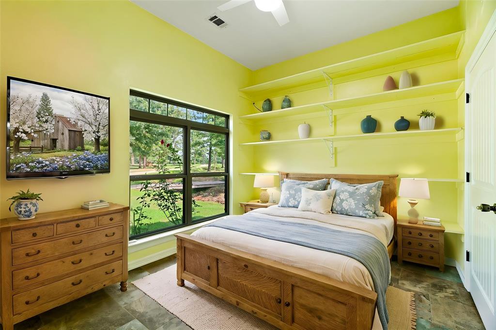 821 County Road Paris, TX 75462 - Photo 14 of 40 Spacious room featuring a large window with exterior views, built-in shelving, ceiling fan, and recessed lighting