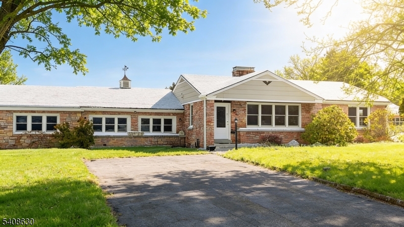 a front view of a house with a yard table and chairs