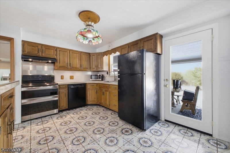 435 Spring Mills Road Milford, NJ 08848 - Photo 12 of 39 a kitchen with stainless steel appliances granite countertop a refrigerator a stove a sink and a microwave