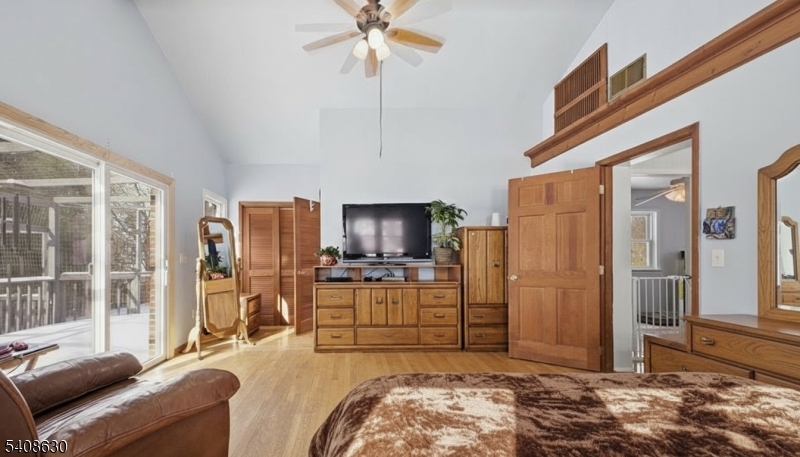 435 Spring Mills Road Milford, NJ 08848 - Photo 17 of 39 a living room with furniture a chandelier and a flat screen tv
