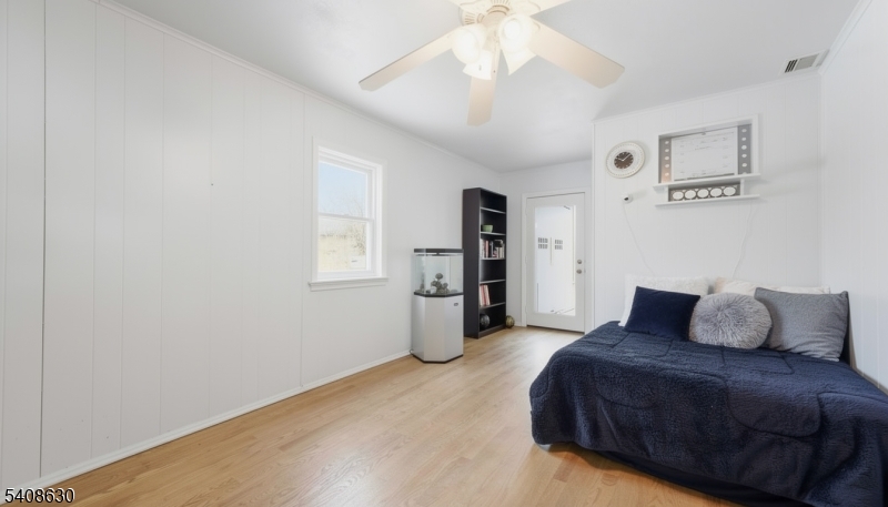 435 Spring Mills Road Milford, NJ 08848 - Photo 24 of 39 a bedroom with a large bed and a chandelier